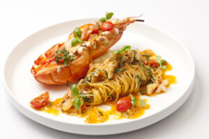 Linguine with lobster brisque, whole lobster, and langoustine tails with garlic, cherry tomatoes and fresh chilli