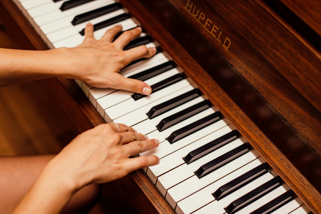 woman's hands playing piano