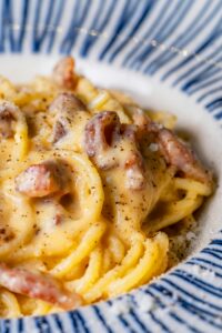 Spaghetti Carbonara – a Roman classic made with creamy egg yolk sauce, crispy guanciale, black pepper, and Pecorino Romano, an authentic Italian favorite from Sicily Restaurant’s à la carte menu.