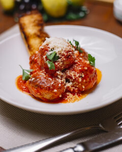 Polpette alla Siciliana – homemade pork and beef meatballs slow-cooked in rich pomodoro sauce, topped with Parmesan cheese, a comforting Italian classic from Sicily Restaurant’s à la carte menu.