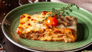 Lasagne dish and glass of red wine. A traditional easter classic in central and southern italy