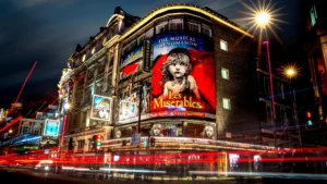 Exterior view of the Sondheim Theatre in London with Les Misérables signage, one of the longest-running West End musicals.